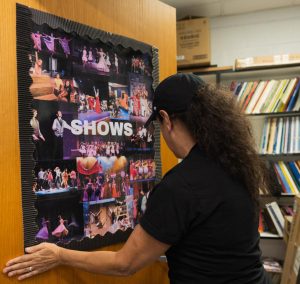 Adjusting her poster of the theater department from Boca Raton High School, musical theatre teacher Stephanie Nixdorf wants to approach her new position at Dreyfoos by embracing what she already knows. With previous theatre teaching experience from LeMoyne College, Suncoast Community High School, and Boca Raton High School, Ms. Nixdorf has had a life dedicated to supporting and coaching the arts. “I just think that having these classes and being able to work with these kids (...) is really enjoyable because the work we do in the classroom, the work we do on these smaller pieces of repertoire, will really help them grow.”
