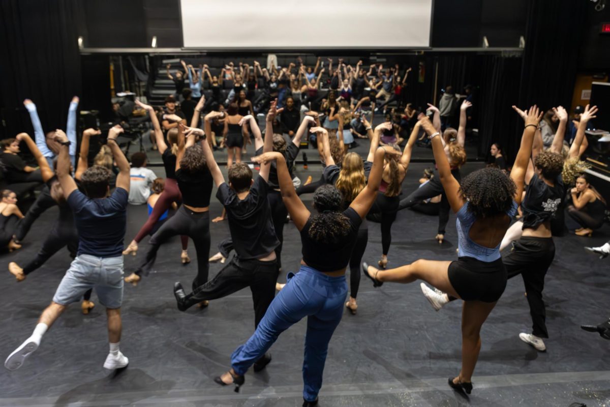 Dancing together in the Brandt Black Box Theater, the “Drowsy Chaperone” cast members practice their routines. This production incorporates numerous dance numbers with the entire cast. “There are so many of us in the cast, (so) it's important for all the dancing to look very specific and sharp,”  ensemble member and theatre senior Erin Duran said. 