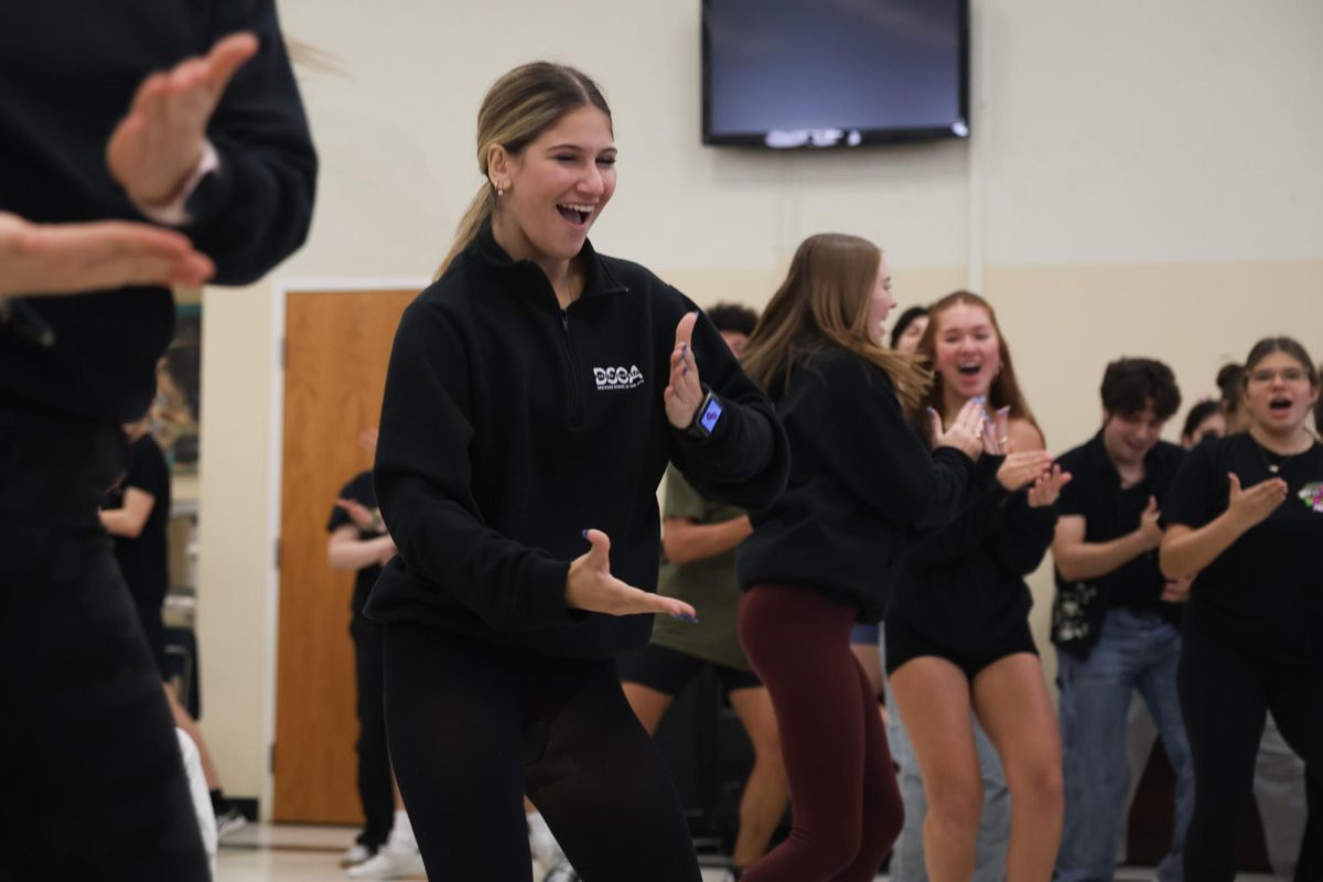 Dancing along to the song “Toledo Surprise,” Drowsy Chaperone dance captain and theatre sophomore Sofia Gianetti participates in the Drowsy Chaperone flash mob. This surprise performance in the cafeteria aimed to promote the upcoming musical and showcase the work and time students put into the musical. “The experience is so much fun, getting to make up all the dances with (theatre teacher Sandra) Christie, assisting her, and helping anyone who has questions,” Gianetti said.