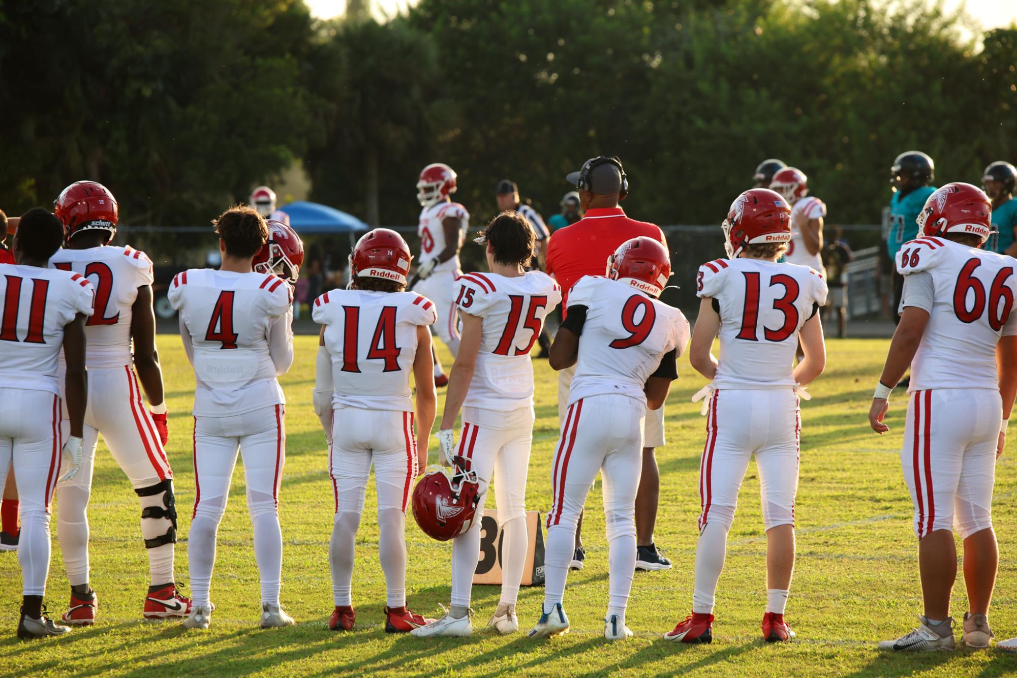 Preparing to enter the field, number 15 and communications senior John Markee watches his teammates from the sidelines. On Friday, Sept. 20, the Forest Hill High School varsity football team played in their fourth game of the season, ending in a loss despite winning their first three games.