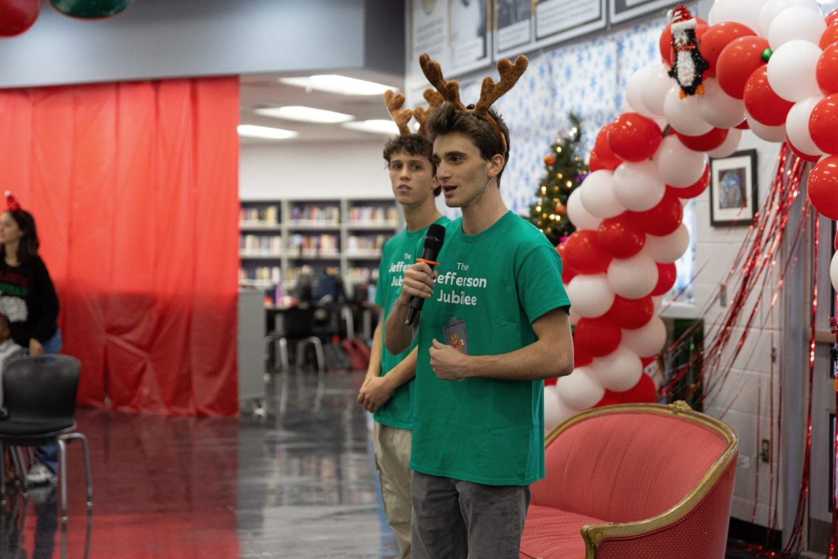 Talking to the children, teachers, and volunteers, ARTS Club co-president and communications senior Jason Monaco gives closing remarks about the annual Jefferson Jubilee celebration. The event is dedicated to helping underprivileged kids celebrate the holiday season.