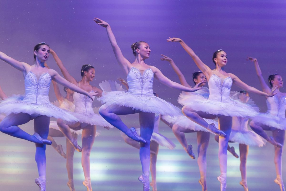 Holding a position en pointe, dance juniors and seniors perform “Snow” in the final number of the Winter Arts Medley. During the piece, a simulated snowfall took place in Meyer Hall.