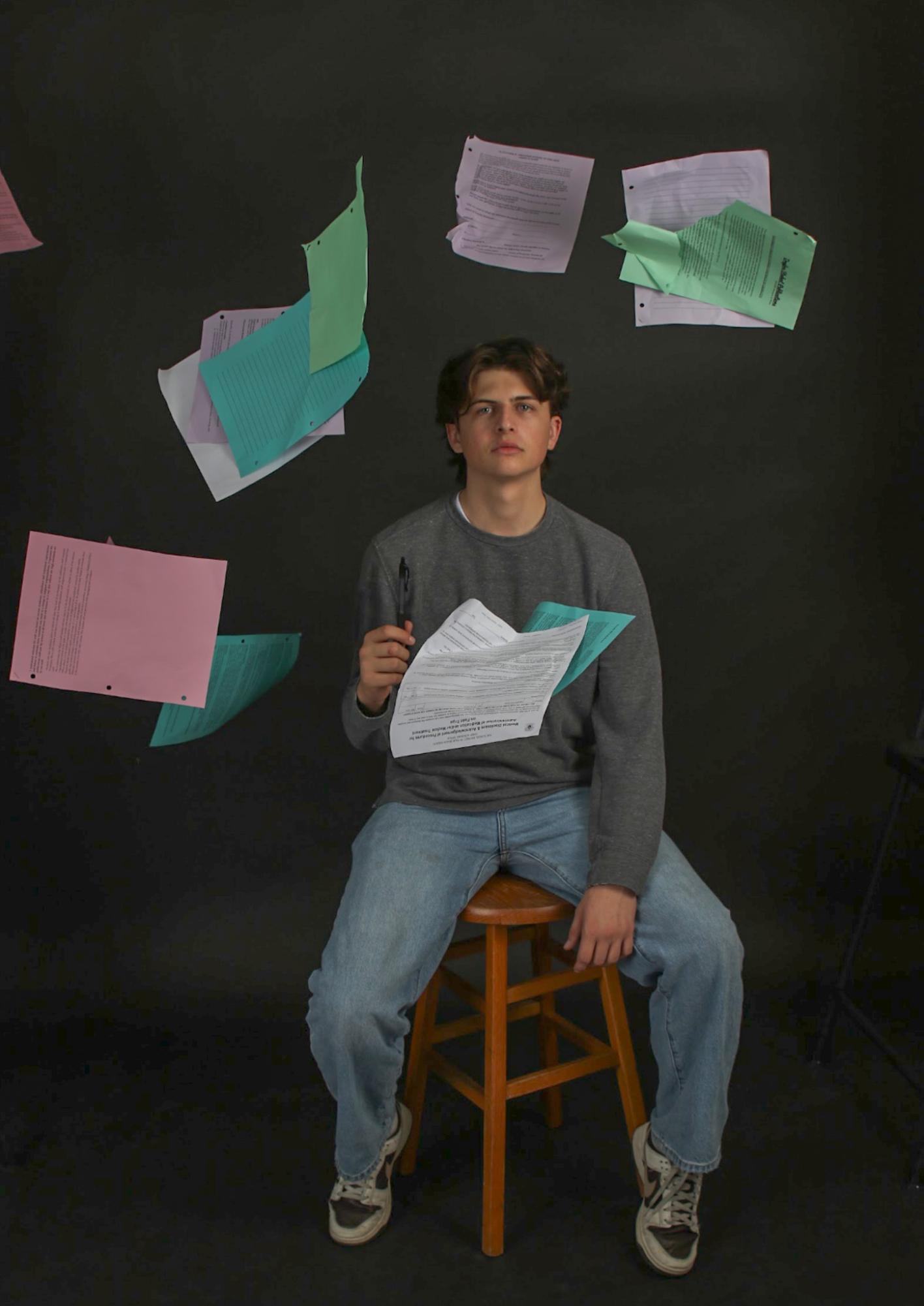 A photo illustration of Griffin Petti surrounded by parental consent forms. 
