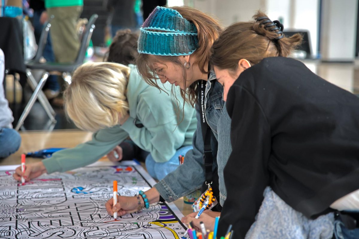 Sitting on the gymnasium floor, theatre senior Rikki Crossland colors on a poster that reads, “Spread Kindness like Confetti,” with other students during the second annual Mental Health Expo, which took place Jan. 24. This lunchtime event, organized by junior class council members piano junior Karen Zhao and theatre junior Juliet Rojas, included activities such as coloring, drumming, and yoga to spread awareness about mental health. The event also included tables representing various organizations in the health field, where students could talk to professionals to learn more about mental health. “I’ve really enjoyed getting to know all of the organizations and all of the representatives of each activity group,” Rojas said. “I definitely have heard a lot of good feedback from students. It is a very enjoyable experience, and I can’t wait to do it again next year.”