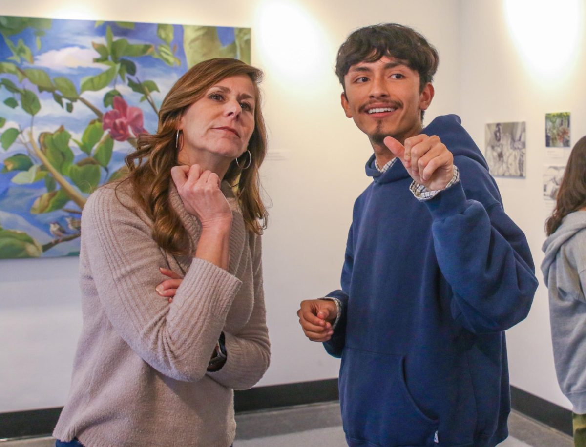 Visual senior Thomas Diaz shows principal Blake Bennet around the art gallery where his pieces are being displayed. Bennet visited the gallery Jan. 10 during lunch along with other guests, including his friends, teachers, and administration. “I went on Monday after school when his whole family came to the exhibit and I got to meet his grandmother, who is pictured in many of the paintings, and that was really special,” Bennet said. “To see her next to the paintings, he is so spot on, and I am so proud of that.”
