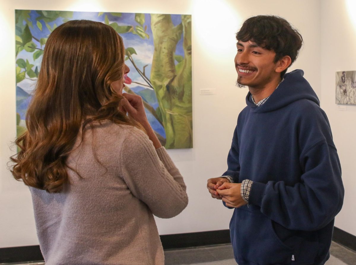 Speaking with Principal Blake Bennett, visual senior Thomas Diaz explains the meaning behind his artwork. On Jan. 10 during lunch, Diaz had his art pieces exhibited in a solo show in the Building 9 gallery in recognition of his creations throughout the year. “It makes me feel very proud of myself because I work really hard, long hours after school,” Diaz said. “It also makes me inspired and hopeful that other people would do the same and want to show their own work. I think there's a lot of very amazing artists in the department that would really benefit from doing a show like this. It really just makes me feel connected to the community.”  