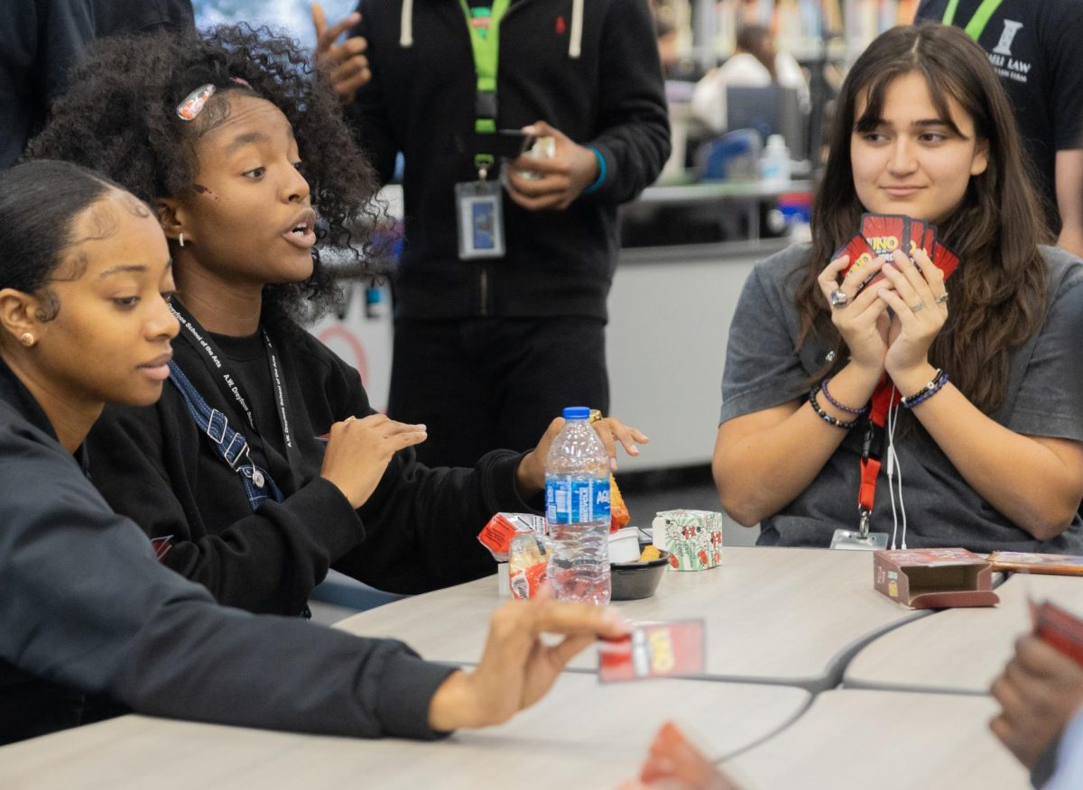 Hiding her cards, digital media junior Camilla Obando plays “UNO Show ‘Em No Mercy” with other students during BSU’s Game Day. “Participating in this event was amazing,” Obando said. “It (the event) was well put together and a fun experience.”
