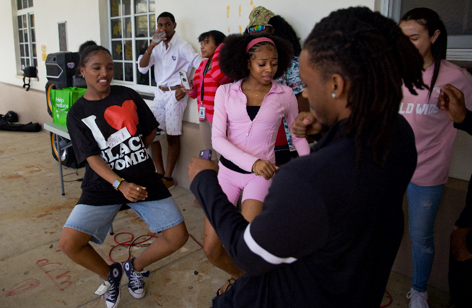 BSU co-president and visual senior Taniyah Aris dances with strings senior Jaynald Obilas and theatre senior Sanai McCray while dancing at the block party. 