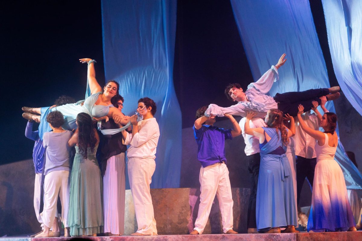 Being held in the air by ensemble members, theatre seniors Melanie Simmons and Shane Rainsburg look at each other while performing the Greek tale of Ceyx and Alcyone in the spring play “Metamorphoses.” Opening night took place Feb. 21 in Meyer Hall, and the show portrayed Greek myths and legends such as those about King Midas and Erysichthon and his Mother. “I love it (the show) so much,” ensemble member and theatre junior Kylie Mraz said. “Portraying (the) magic of Greek gods and goddesses into lights and sound was so difficult but so worth the effort.”