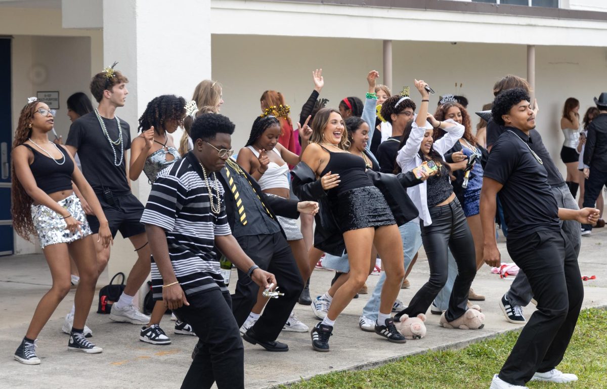 Seniors sing and dance along to “ Wobble” by V.I.C. to celebrate the kickoff of their last Spirit Week.
