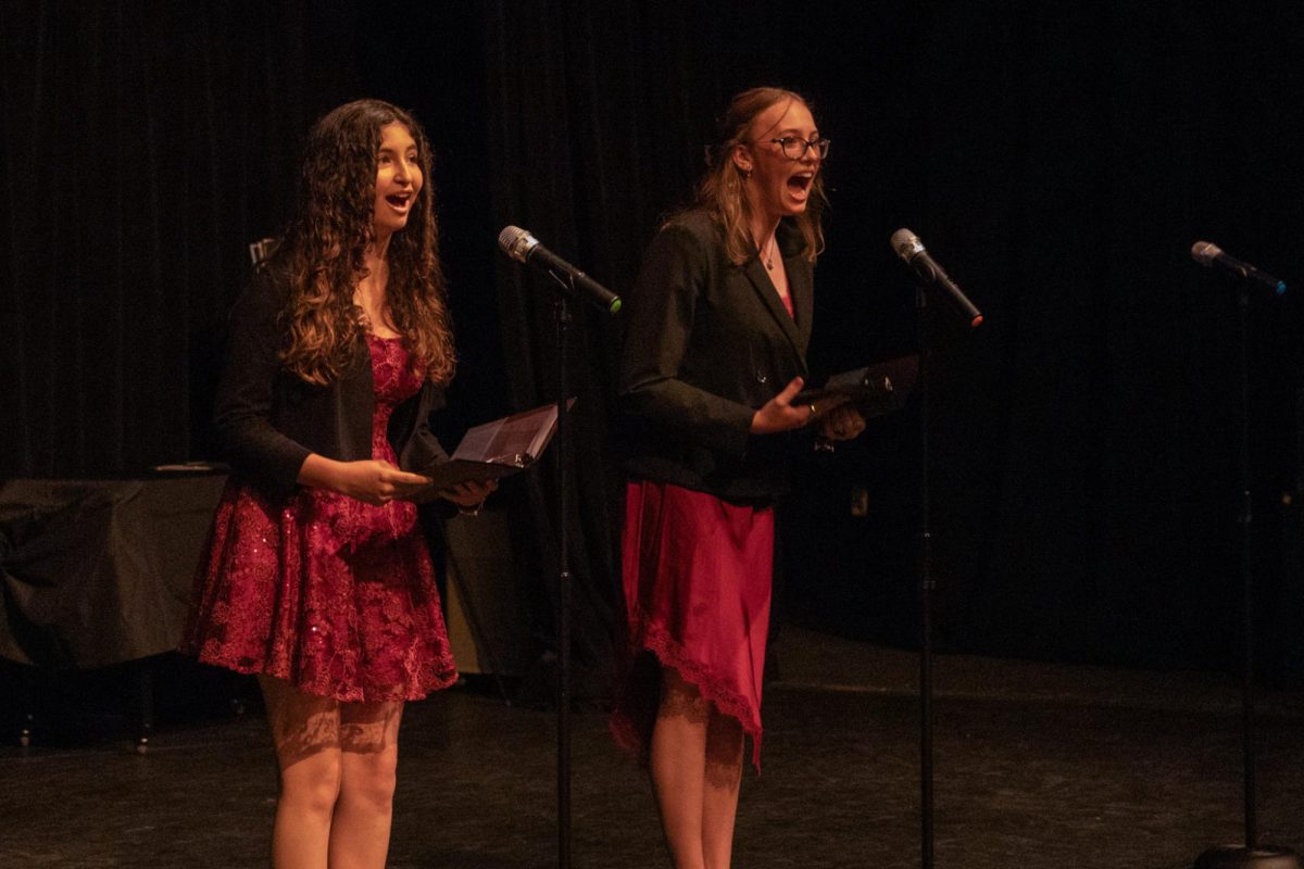 Yelling into the microphones, communications freshmen BellaDonna Petersen and Monica Chirolde perform their speech “Playground” at the Figure of Speech showcase on March 6. In this speech event, called Duo Interpretation, participants base their performance on a previously written piece of work of their choosing.