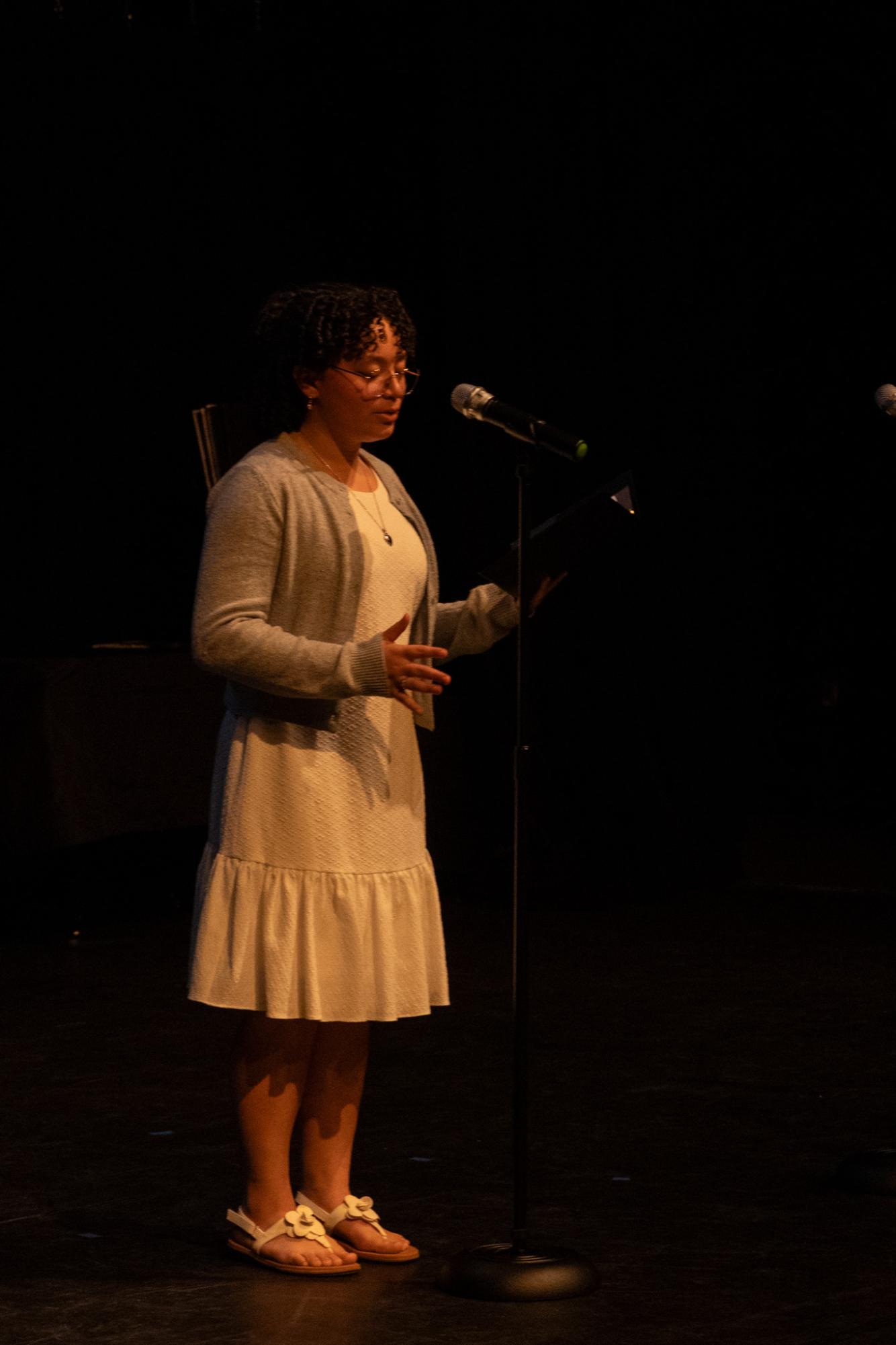 Standing in the center of the Brandt Black Box Theatre stage, communications senior Anna Chavez performs her original slam poem "Bambi."