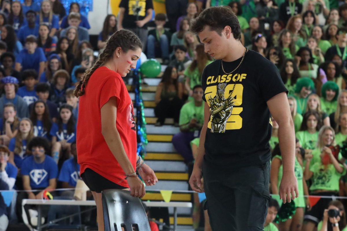 Circling the singular chair during the last round of musical chairs, strings junior Lily Mcdow and theatre senior Kenneth Quinter wait in anticipation for the song “Mo Chicken” by BossMan Dlow and French Montana to stop. The senior class won this game with the juniors in second place, sophomores in third, and freshmen in last.