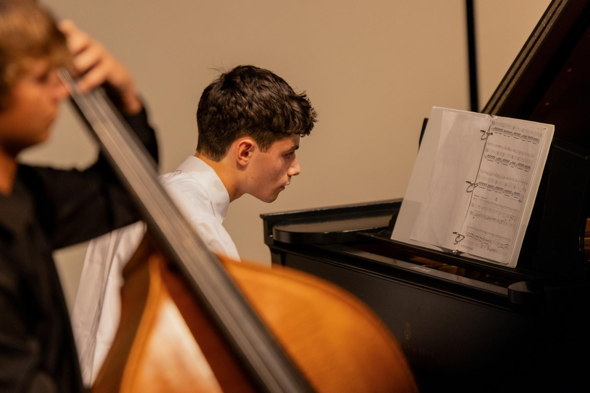 Performing the piece titled “Sonata ‘1963’ Movements 1-2” with strings senior Charles Debay, piano senior Noah Kriegstein plays his final piece for the Klavier Infinity Keys recital. “For each individual year, I see more growth from when they (piano students) come in as freshmen and when they leave as seniors,” music department dean and piano teacher Stefanie Katz Shear said. “That's where I really see the growth and how they become wonderful, well-rounded musicians.”