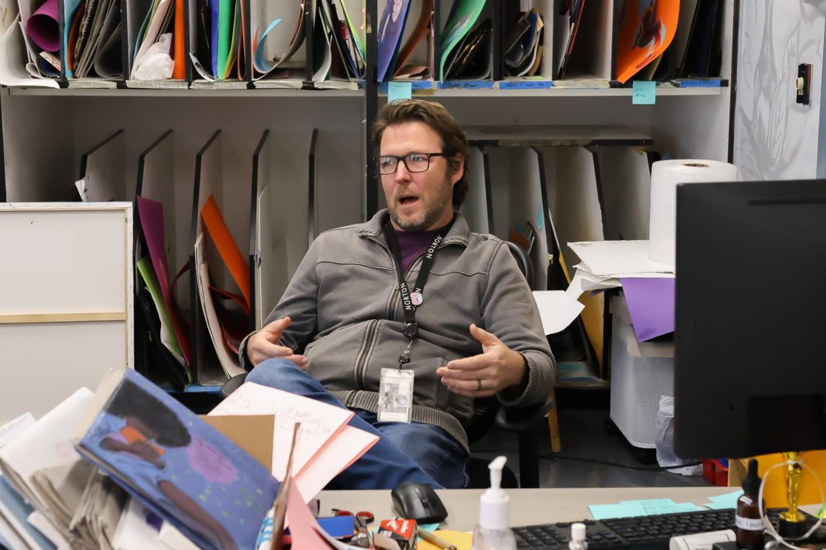 Sitting in his art classroom, visual teacher Ryan Toth explains his ideas and process for creating his new Spirit Week costumes. According to Mr. Toth, some costumes are planned days in advance, and others are made the night before each dress-up day, utilizing items like taxidermied skunks and “old wigs found in (his) house.”